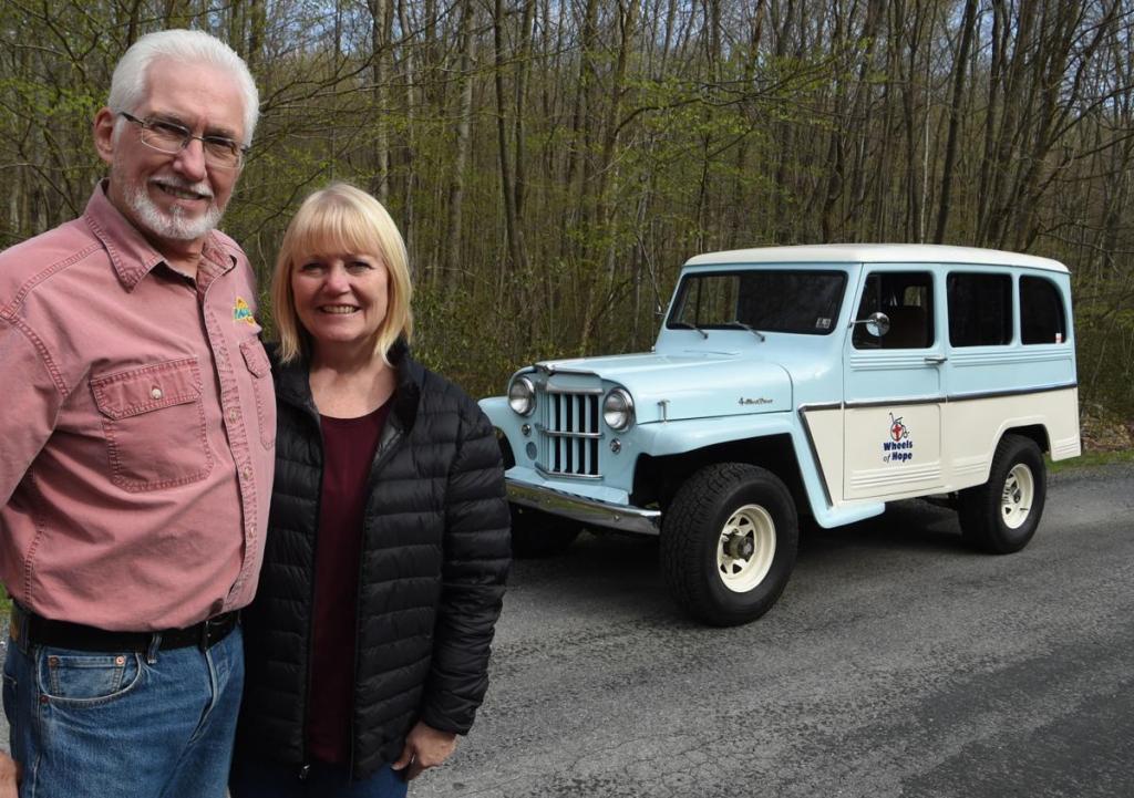 Pat and Mary Simons with the 1962 Willys Jeep they use to promote Wheels of Hope